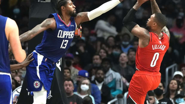 Oct 25, 2021; Los Angeles, California, USA; Portland Trail Blazers guard Damian Lillard (0) tries to shoot over LA Clippers guard Paul George (13) during the third quarter at Staples Center. Mandatory Credit: Robert Hanashiro-USA TODAY Sports